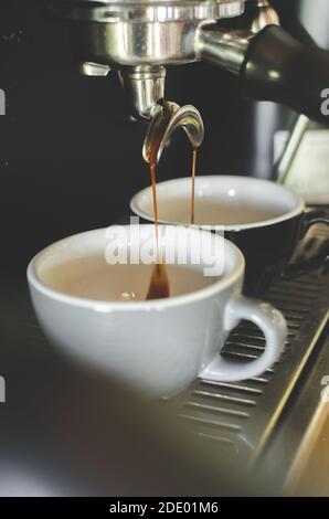Single und Double Espresso in einer kleinen Tasse mit Kaffeemaschine in einem Café in Canggu, Bali, Indonesien Stockfoto