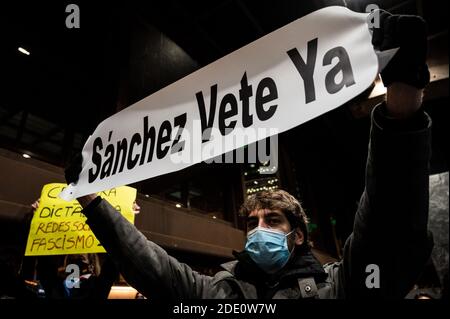 Madrid, Spanien. November 2020. Ein Mann, der eine Gesichtsmaske trägt, um sich vor der Ausbreitung des Coronavirus zu schützen, protestiert mit einem Plakat mit der Aufschrift "Sanchez go away now" während einer Demonstration gegen Zensur in sozialen Netzwerken vor dem Hauptquartier von Twitter. Quelle: Marcos del Mazo/Alamy Live News Stockfoto