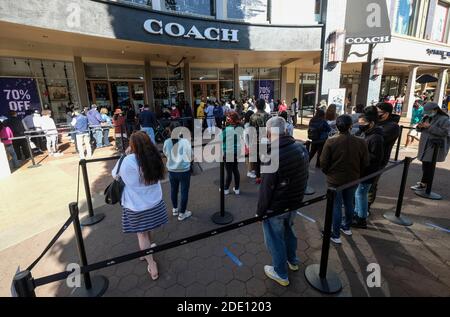 Commerce, Kalifornien, USA. November 2020. Während der Coronavirus-Pandemie in Commerce, Kalifornien, Freitag, warten die Käufer mit Gesichtsmasken in der Schlange, um am Schwarzen Freitag in den Citadel Outlets ein Geschäft zu betreten. Kredit: Ringo Chiu/ZUMA Wire/Alamy Live Nachrichten Stockfoto
