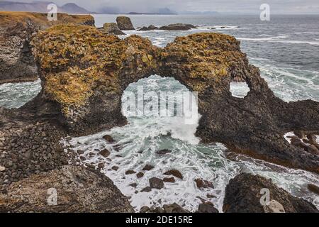 Ein Felsbogen zwischen Basalt Lavaklippen bei Arnastapi, an der Küste der Halbinsel Snaefellsnes, West Island, Polarregionen Stockfoto