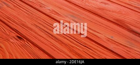 ORANGE. Bemalte alte Holzwand. ORANGE Hintergrund Holz ORANGE Plank Hintergrund Stockfoto
