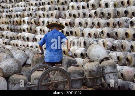 Mann stapelt Weingläser auf den großen Stapel in einem Weingut, Linhai, Provinz Zhejiang, China Stockfoto