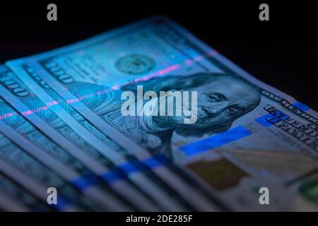 100 Dollar Banknot Währung in UV-Lichtschutz.Dollar in UV Licht.Geld aus der Nähe prüfen Stockfoto