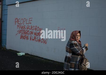 Glasgow, Schottland, Großbritannien, 28. November 2020. Fußgänger passieren neu bemalte Graffiti mit der Aufschrift "People Make Glasgow, Sturgeon won won't break Glasgow", ein Verweis auf die Politik des schottischen Ersten Ministers Nicola Sturgeon, geschrieben auf einer Wand im Wahlkreis von Nicola Sturgeon in Govanhill, im Süden der Stadt. Foto: Jeremy Sutton-Hibbert/ Alamy News. Stockfoto