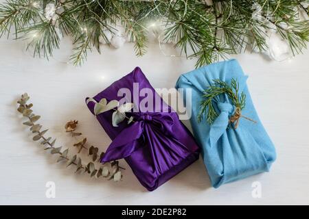 Handgemachte weihnachts-Geschenkboxen in Textil-Tuch in japanischen traditionellen furoshiki-Stil gewickelt. Schöne Grußkarte Design, Null Abfall und diy-Konzepte Stockfoto