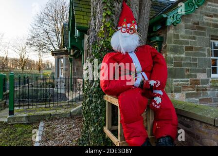 East Lothian, Schottland, Großbritannien, 28. November 2020. Weihnachtsschmuck: Eine lebensgroße Santa Vogelscheuche Figur ist in Dirleton Village als Kunst der Gemeinschaft Weihnachtsschmuck erschienen Stockfoto