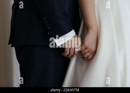 Braut hält seine Verlobte Hand. Nahaufnahme paar Hände. Verliebte Paare Stockfoto