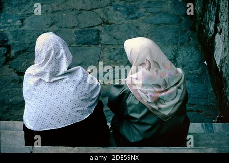 Paar traditionelle türkische Frauen tragen Kopftücher & traditionelle Kleidung Und plaudern vor der Haustür Bursa Türkei Stockfoto