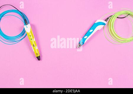 3d-Stifte mit buntem Kunststoff-Filament auf rosa Hintergrund Stockfoto