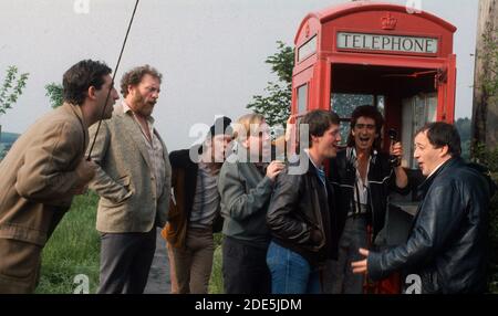 Aktion durch eine rote Telefonbox - Original Cast of Die ATV-Produktion von auf Wiedersehen Pet fotografiert bei A Nottinghamshire Standort Juli 1986 Stockfoto