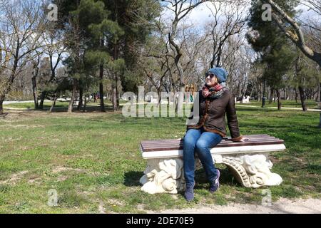 Frau, die im Frühling auf der Bank sitzt, Malakhov Kurgan, Sewastopol Stockfoto