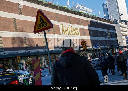 Stockholm - 02/07/2017: Mann von hinten zu Fuß in Klarabergsviadukten im Winter vor Ahlens Einkaufszentrum Stockfoto