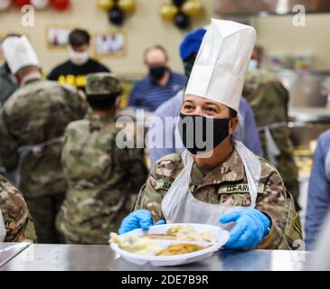 Mitglieder der 1. Panzerdivision der US-Armee servieren den Dienstmitgliedern im Lager Buehring am 26. November 2020 in Buehring, Kuwait, traditionelles Thanksgiving-Dinner. Stockfoto