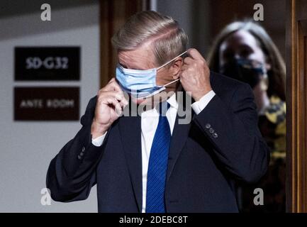 Washington, Usa. November 2020. Senator Lindsey Graham aus South Carolina passt seine Gesichtsmaske an, als er zur Anhörung des Justizausschusses des Senats über die Moderation der Präsidentschaftswahlen 2020 durch Twitter und Facebook am Dienstag, den 17. November 2020, auf dem Kapitol anreist. Graham, ein Republikaner, hat offenbar Georgiens Außenminister gebeten, einen Weg zu finden, um einige Mail-in-Stimmzettel zu verwerfen, die Biden gegenüber Trump favorisierten. Der designierte Präsident Joe Biden gewann Georgien. Pool Foto von Bill Clark/UPI Kredit: UPI/Alamy Live Nachrichten Stockfoto