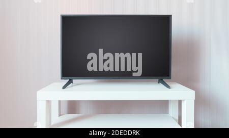 Schwarzer LCD-Fernseher mit leerem Bildschirm auf weißem Ständer vor beigefarbenem Wandhintergrund. Platz auf dem Bildschirm kopieren Stockfoto