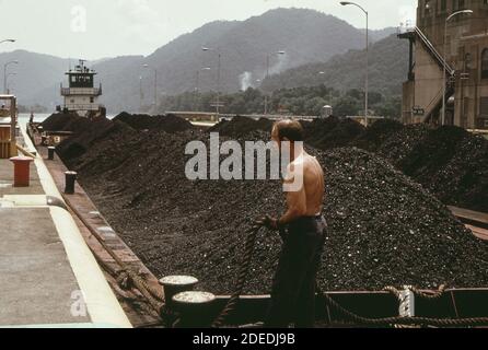 1970er-Jahre Foto (1973) - EIN Coalburger Schlepper und acht Kohlehähne gehen stromabwärts durch die londoner Schleusen; eines von drei Schleusenanlagen am Kanawha River Stockfoto