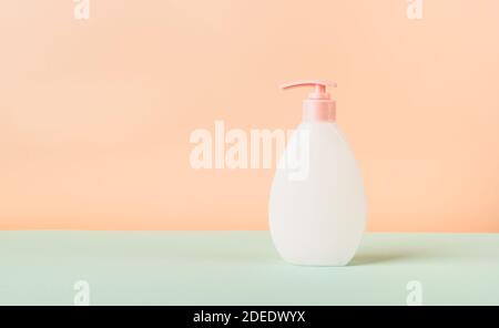 Flasche mit Spender Gel Schaum antiseptische Creme kosmetisches Produkt auf modernen abstrakten Podium auf pastellfarbenem Hintergrund. Vorlage für die Werbung Kosmetik pro Stockfoto