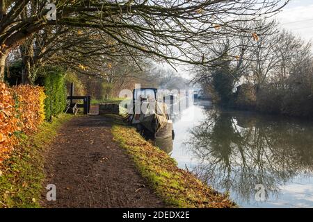 Kanalboote vertäuten im Spätherbst am Kennet und Avon Kanal an einem sonnigen nebligen Wintermorgen, Bradford on Avon, Wiltshire, Großbritannien Stockfoto