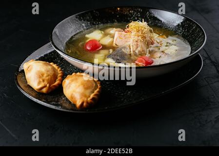 Fischsuppe mit Kabeljau auf schwarzem Hintergrund Stockfoto