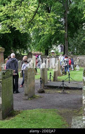 Auld Kirk , Alloway, Ayrshire, Schottland, Großbritannien. 24 Mai 2014. Die Menschen schauen sich den Auld Kirk Friedhof an und schauen sich die Geschichte der Gräber an, die mit dem Dichter Robert Burns verbunden sind Stockfoto