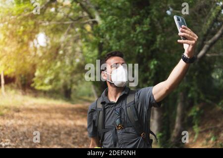 Der Junge macht mit seinem Handy ein Selfie in den Bergen. Wanderroute in den Bergen. Konzept der Gesundheit. Berg Stockfoto