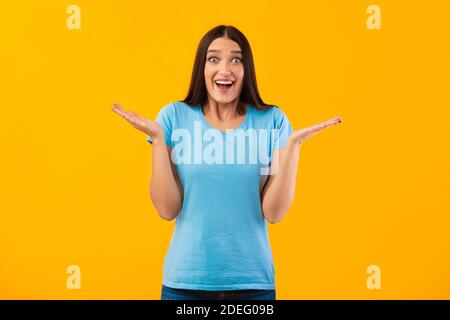 Beeindruckt Frau spreizen Hände Blick auf Kamera Stockfoto