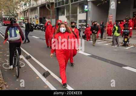 Barcelona, Spanien. November 2020. Demonstranten mit Gesichtsmasken und Kostümen der Money Heist Serie marschieren während der Demonstration auf der Straße. Dutzende von Menschen versammelten sich am Hauptsitz des Haya Real Estate Investmentfonds, verbunden mit der Firma Cerberus, in Barcelona. Kollektive zur Verteidigung von Wohnungen haben einen Protest mit hundert Aktivisten organisiert, um die Einstellung von Räumungen zu fordern und eine Verhandlung mit einem Vertreter des Unternehmens zu fordern. Kredit: SOPA Images Limited/Alamy Live Nachrichten Stockfoto