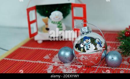 Schneemann silberne Kugel mit zwei blauen Perlen Stockfoto