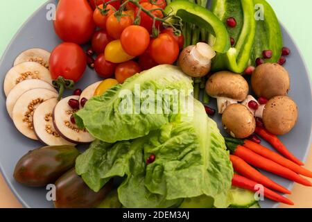 Nahaufnahme von frisch geschnittenem Gemüse auf grauem Teller Stockfoto