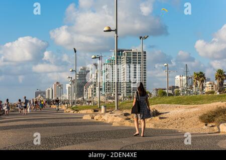 Viele Touristen zu Fuß im Sir Charles Clore Park und Hintergrund von hohen Skylines und Luxushotels entlang der Tel Aviv Beach Stockfoto