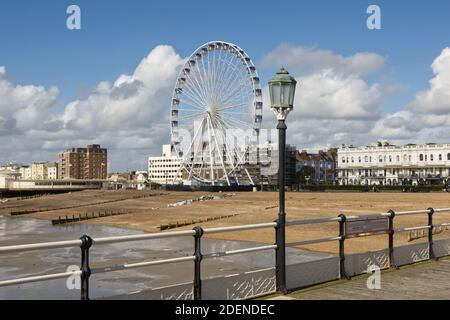 Strandpromenade und Strand in Worthing, West Sussex, England. Mit Riesenrad vom Pier aus gesehen. Stockfoto