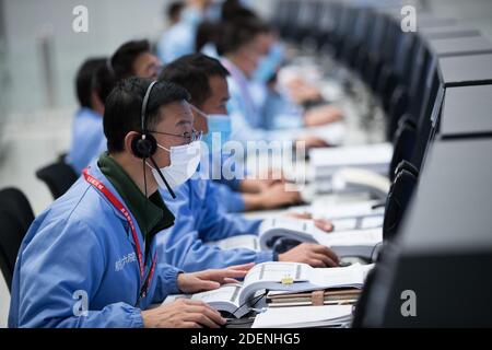 (201201) -- PEKING, 1. Dezember 2020 (Xinhua) -- Technische Mitarbeiter arbeiten im Beijing Aerospace Control Center (BACC) in Peking, Hauptstadt von China, 1. Dezember 2020. Chinas Chang'e-5-Raumschiff landete erfolgreich auf der nahen Seite des Mondes am späten Dienstag und schickte Bilder zurück, teilte die China National Space Administration (CNSA) mit. Um 11:11 Uhr landete das Raumschiff auf dem vorgewählten Landegebiet in der Nähe von 51.8 Grad westlicher Länge und 43.1 Grad nördlicher Breite, sagte die CNSA. Während des Landevorgangs machten die Kameras an Bord des Landers Bilder vom Landegebiet, sagte die CNSA. (Xinhu Stockfoto