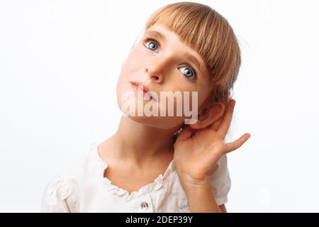 Baby Mädchen belauschen oder hören, im Studio auf weißem Hintergrund Stockfoto