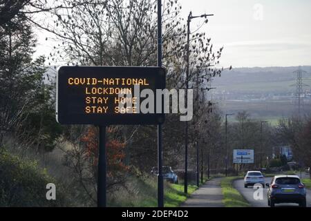 Ein elektronisches Verkehrsschild mit variablen Nachrichten, das Coronavirus-Informationen und anzeigt Beratung bei der Sperrung des zweiten nationalen Corona-Virus Stockfoto