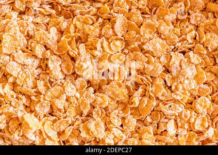 Frosted Corn Flocken Nahaufnahme Hintergrund. Ein zuckersüßes Lieblingsfrühstück. Stockfoto
