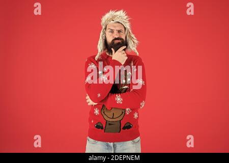 Harte Entscheidung. Die Entscheidungsfindung. Zu Weihnachten wünschen. Lebensverändernde Entscheidung. Hipster bärtiger Mann tragen winter Pullover und Hut. Frohes neues Jahr. Winter party Outfit. Man nachdenkliche Gesichtsausdruck. Stockfoto