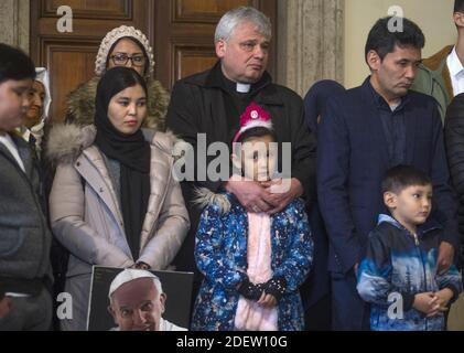 Polens Kardinal und päpstlicher Almoner Konrad Krajewski mit einer Gruppe von Migranten. Papst Franziskus trifft sich am 19. Dezember 2019 im Vatikan vor kurzem kamen 33 Flüchtlinge von der griechischen Insel Lesbos an und enthüllt ein Kreuz mit Rettungsweste im Belvedere-Hof des Vatikans, um an alle Migranten und Flüchtlinge zu erinnern, die gefährliche Reisen auf der Suche nach einem besseren Leben Unternehmen. Foto von ABACAPRESS.COM Stockfoto