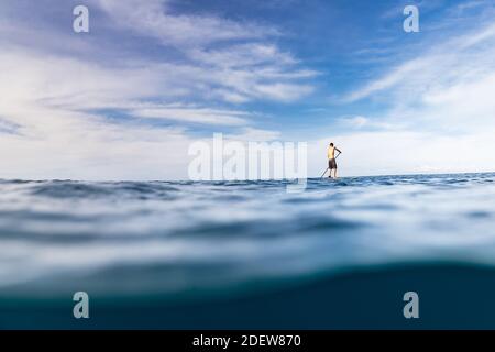 Stand Up Paddler paddeln solo im Ozean von hawaii Stockfoto