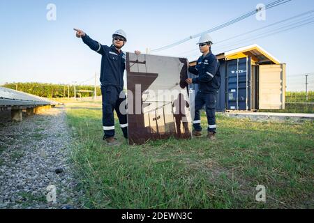 Techniker hebt die Solarzelle, um die beschädigte zu ersetzen, Alternative Energie, um die Energie der Welt zu sparen. Stockfoto