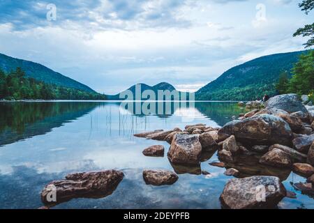 Acadia's Bubbles spiegelte sich in einem ruhigen Jordan Pond auf einem Sommerabend Stockfoto