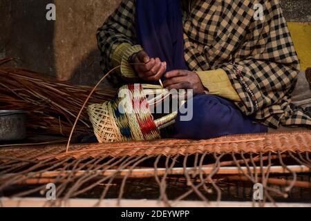 Srinagar, Indien. Dezember 2020. Ein Kashmiri-Mann macht einen 'Kangri', einen traditionellen Feuertopf in seiner Werkstatt am Stadtrand von Srinagar, der Sommerhauptstadt von Jammu und Kaschmir.der Kangri ist ein traditioneller Feuertopf, der die Menschen während der schweren Wintermonate warm hält, wenn die Temperatur bis zu minus 20 abnimmt. Kangri ist aus Ton und Zweigen, in denen heiße Kohle gehalten wird. Kredit: SOPA Images Limited/Alamy Live Nachrichten Stockfoto