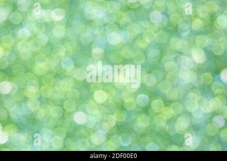 Abstrakt glühenden hellgrünen Hintergrund, Textur, Glitter ein vintage Blendung, Bokeh Hintergrund Stockfoto