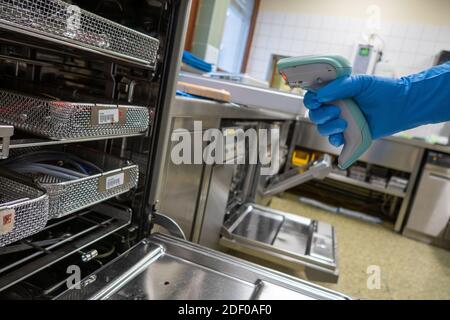 Der Mitarbeiter des Krankenhauses scannt die Geräteschalen mit einem Barcode-Scanner Stockfoto