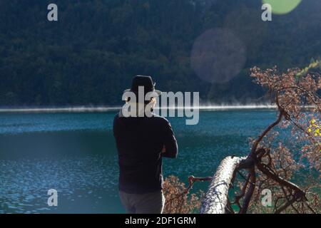 Ein Hutmensch, der über einen klaren Bergsee schaut Deutschland Stockfoto