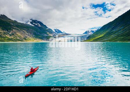 Frau Kajak im Glacier Bay National Park mit Gletscher in Hintergrund Stockfoto