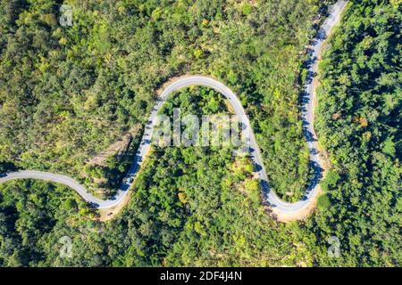 Luftaufnahme über Berg Straße durch tropischen Regenwald Landschaft in Thailand gehen. Stockfoto