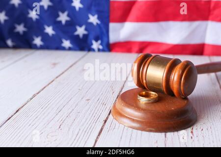 Scheidungskonzept mit Gavel und Eheringen auf Tisch. Stockfoto