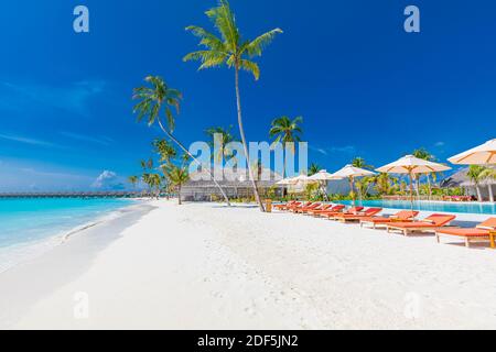 Strandlandschaft. Luxuriöses Strandresort mit Pool und Liegen oder Liegen unter Sonnenschirmen mit Palmen, Urlaub, Urlaub Stockfoto