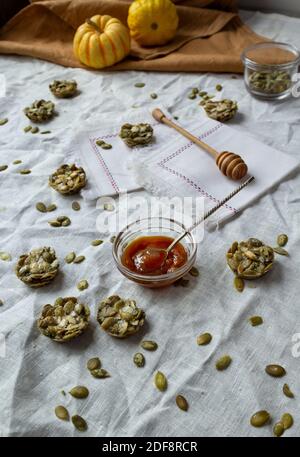 Bio-Süßigkeiten mit Kürbiskernen. Fitness-Cookies auf einer Leinentischdecke. Einfarbige Farben Stockfoto