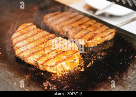 Zwei Schweinekoteletts, Steaks, gegrillt auf elektrischem Grill Stockfoto